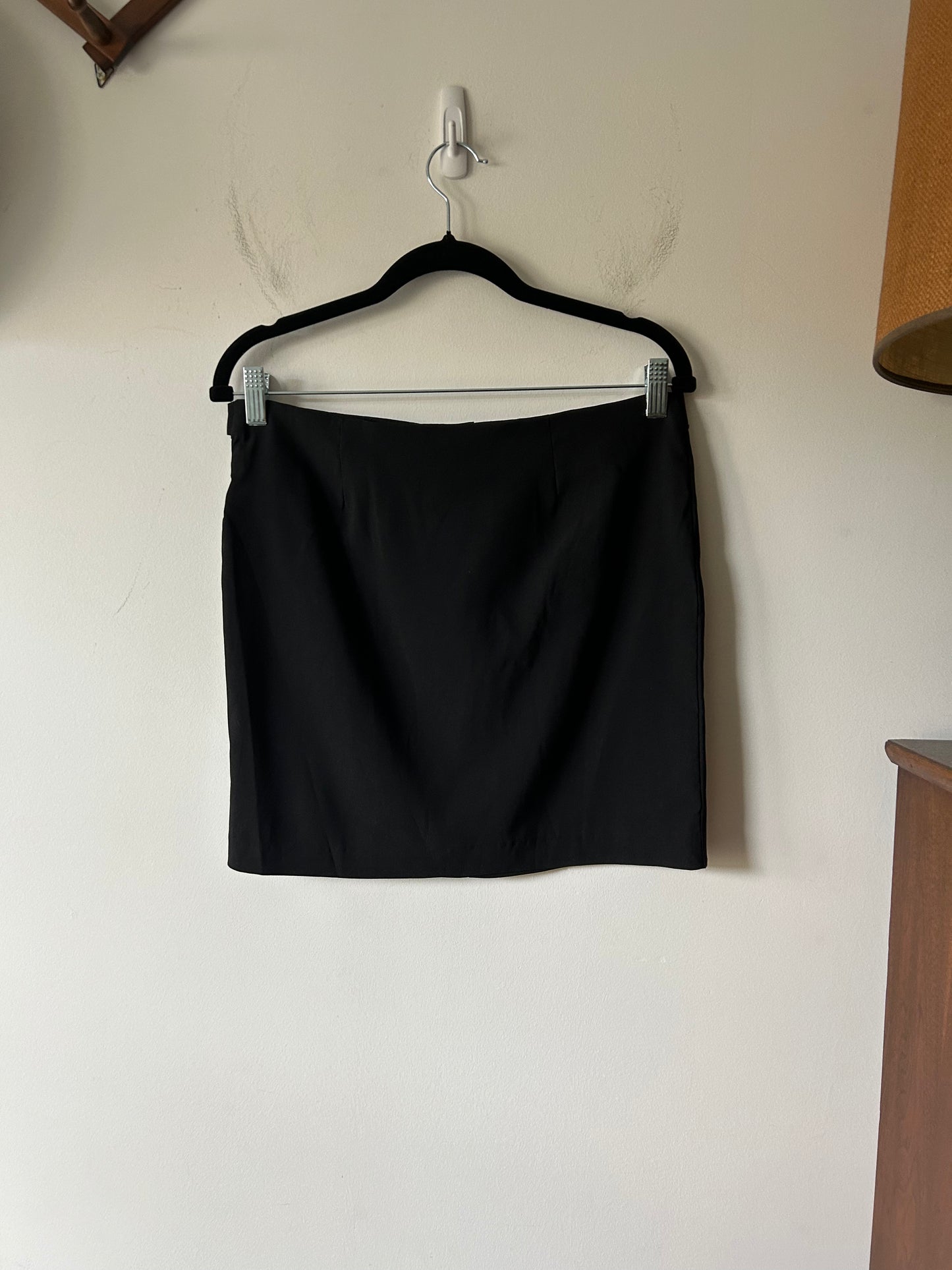 black mini skirt with buckle detail