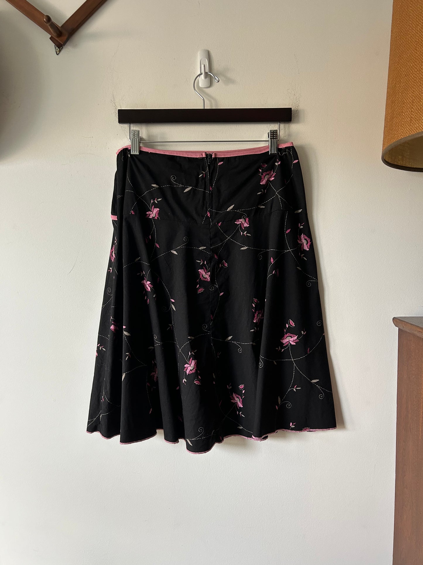 black skirt with embroidered pink floral details