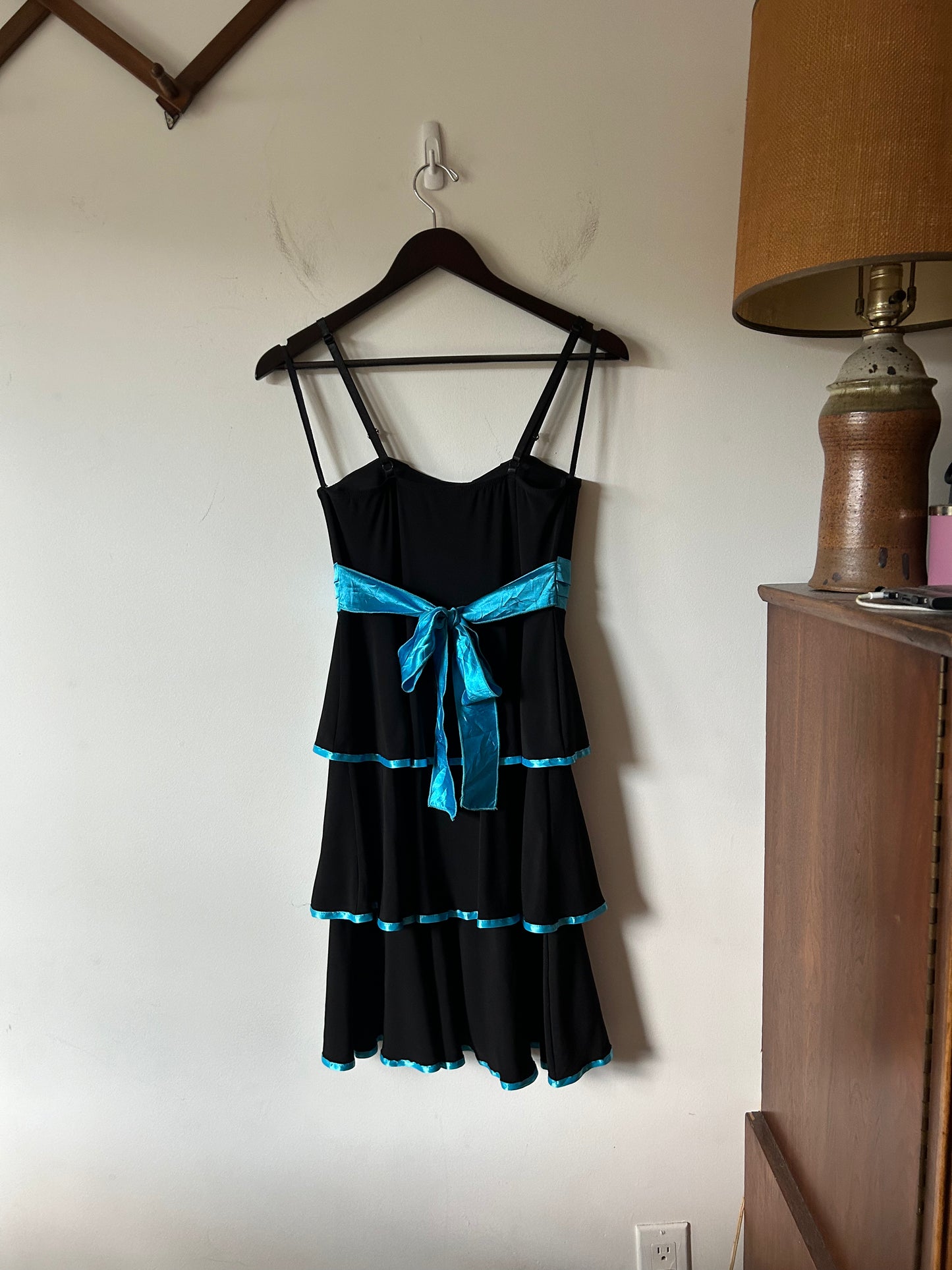 Deb layered black gown with teal piping and rhinestones