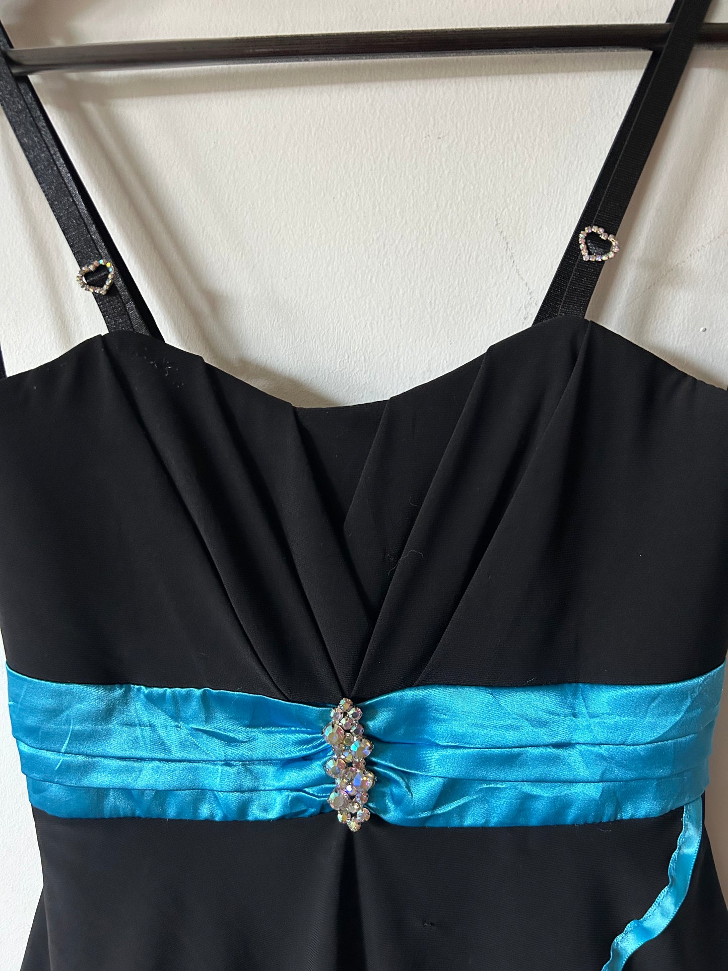 Deb layered black gown with teal piping and rhinestones