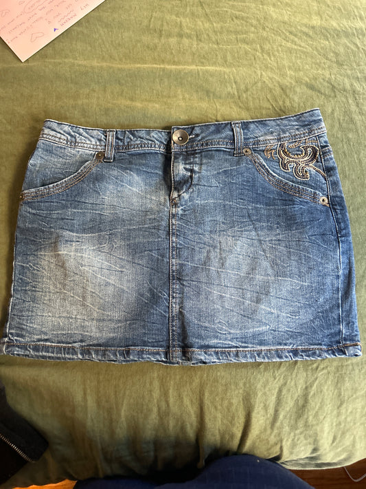Denim mini skirt pocket embellishment