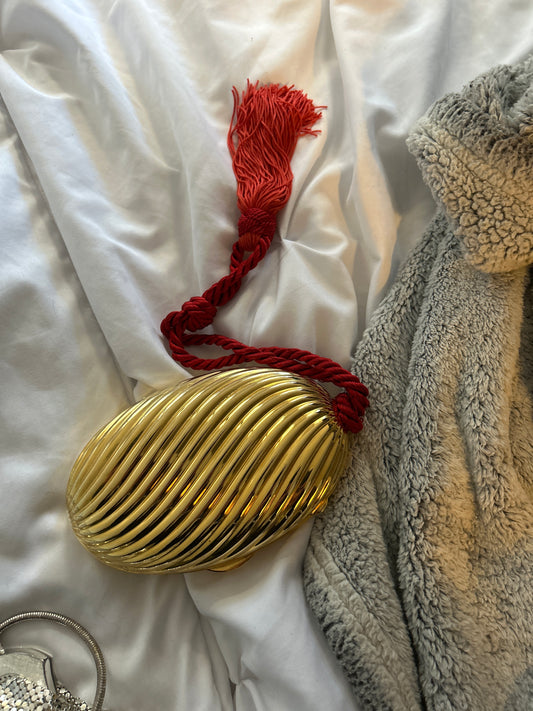 Gold purse with red cord