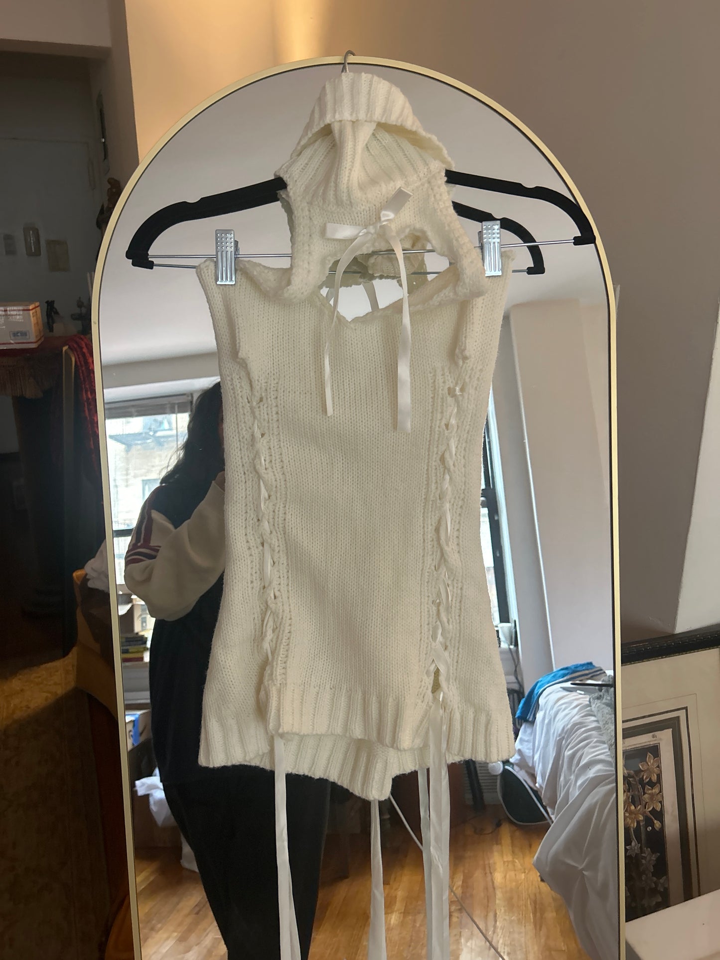 White sleeveless sweater ribbons