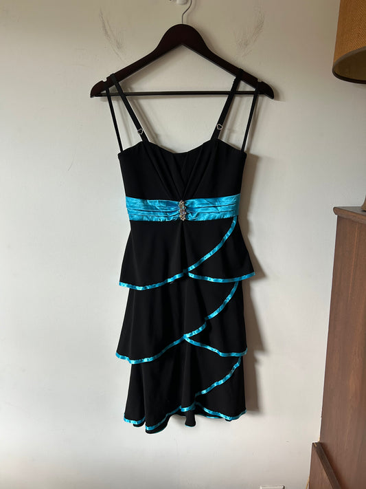 Deb layered black gown with teal piping and rhinestones