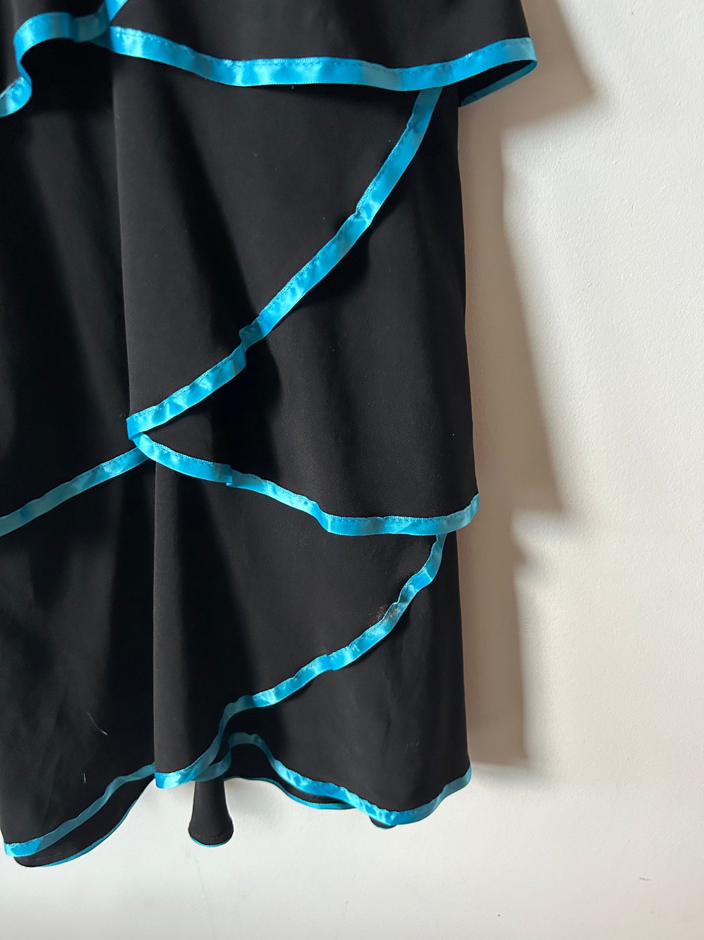 Deb layered black gown with teal piping and rhinestones